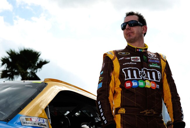 DAYTONA BEACH, FL - FEBRUARY 19:  Kyle Busch, driver of the #18 M&M's Brown Toyota, gets out of his car during qualifying for the NASCAR Sprint Cup Series Daytona 500 at Daytona International Speedway on February 19, 2012 in Daytona Beach, Florida.  (Photo by Jared C. Tilton/Getty Images for NASCAR)