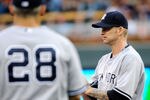 MINNEAPOLIS, MN - AUGUST 20: A.J. Burnett #34 of the New York Yankees reacts as Joe Girardi #28 of the New York Yankees walks out to the mound to relieve Burnett in the second inning against the Minnesota Twins on August 20, 2011 at Target Field in Minneapolis, Minnesota. (Photo by Hannah Foslien/Getty Images)