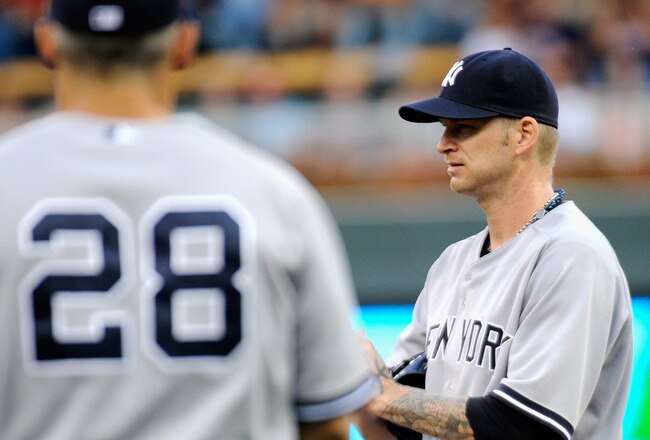 MINNEAPOLIS, MN - AUGUST 20: A.J. Burnett #34 of the New York Yankees reacts as Joe Girardi #28 of the New York Yankees walks out to the mound to relieve Burnett in the second inning against the Minnesota Twins on August 20, 2011 at Target Field in Minneapolis, Minnesota. (Photo by Hannah Foslien/Getty Images)