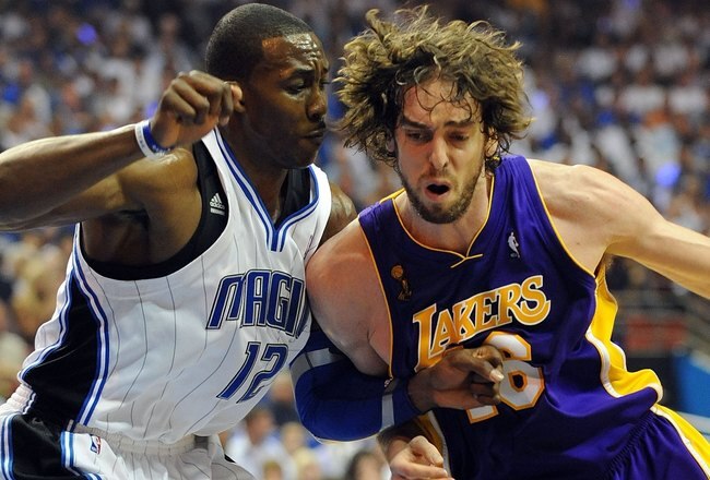 ORLANDO, FL - JUNE 14:  Pau Gasol #16 of the Los Angeles Lakers drives on Dwight Howard #12 of the Orlando Magic in Game Five of the 2009 NBA Finals on June 14, 2009 at Amway Arena in Orlando, Florida.  NOTE TO USER:  User expressly acknowledges and agrees that, by downloading and or using this photograph, User is consenting to the terms and conditions of the Getty Images License Agreement.  (Photo by Ronald Martinez/Getty Images)