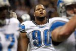 NEW ORLEANS, LA - JANUARY 07:   Ndamukong Suh #90 of the Detroit Lions looks on during warm ups prior to playing against the New Orleans Saints in the 2012 NFC Wild Card Playoff at Mercedes-Benz Superdome game on January 7, 2012 in New Orleans, Louisiana.  (Photo by Ronald Martinez/Getty Images)