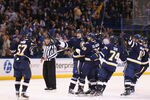ST. LOUIS, MO - FEBRUARY 11: Patrik Berglund #21 and Carlo Colaiacovo #28 both of the St. Louis Blues are mobbed by teammates after Colaiacovo scored the game-winning against the Colorado Avalanche at the Scottrade Center on February 11, 2012 in St. Louis, Missouri.  The Blues beat the Avalanche 3-2 in overtime.  (Photo by Dilip Vishwanat/Getty Images)
