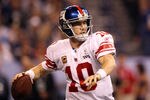 INDIANAPOLIS, IN - FEBRUARY 05:  Quarterback Eli Manning #10 of the New York Giants looks to pass the ball while taking on the New England Patriots during Super Bowl XLVI at Lucas Oil Stadium on February 5, 2012 in Indianapolis, Indiana.  (Photo by Ezra Shaw/Getty Images)
