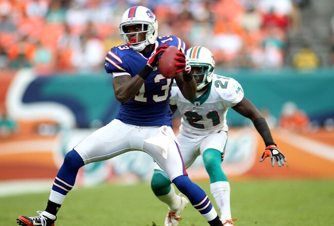 MIAMI GARDENS, FL - NOVEMBER 20:  Receiver Stevie Johnson #13 of the Buffalo Bills makes a catch in front of Cornerback Vontae Davis #21 of the Miami Dolphins at Sun Life Stadium on November 20, 2011 in Miami Gardens, Florida.  (Photo by Marc Serota/Getty Images)