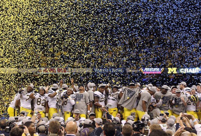 NEW ORLEANS, LA - JANUARY 03:  The Michigan Wolverines celebrate as confetti falls after they won 23-20 against the Virginia Tech Hokies during the Allstate Sugar Bowl at Mercedes-Benz Superdome on January 3, 2012 in New Orleans, Louisiana.  (Photo by Matthew Stockman/Getty Images)