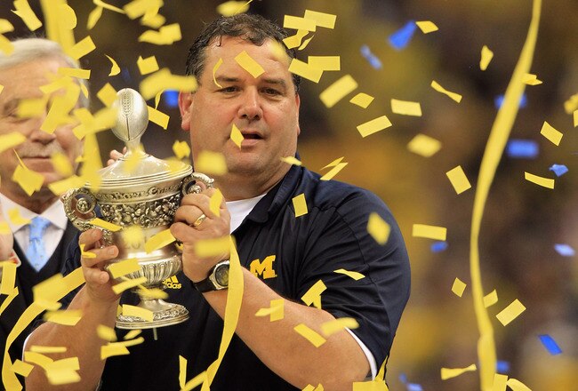 NEW ORLEANS, LA - JANUARY 03:  Head coach Brady Hoke of the Michigan Wolverines celebrates with the trophy after Michigan won 23-20 in overtime against the Virginia Tech Hokies during the Allstate Sugar Bowl at Mercedes-Benz Superdome on January 3, 2012 in New Orleans, Louisiana.  (Photo by Matthew Stockman/Getty Images)
