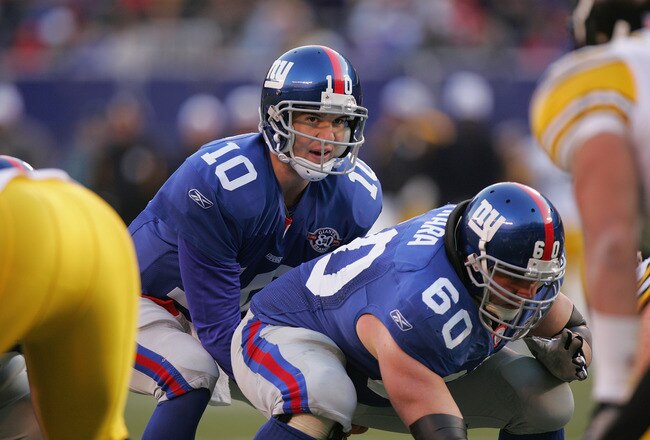 EAST RUTHERFORD, NJ - DECEMBER 18:  Eli Manning #10 of the New York Giants lines up under center Shaun O'Hara #60 during the game against the Pittsburgh Steelers at Giants Stadium on December 18, 2004 in East Rutherford, New Jersey. The Steelers won 33-30.  (Photo by Ezra Shaw/Getty Images)