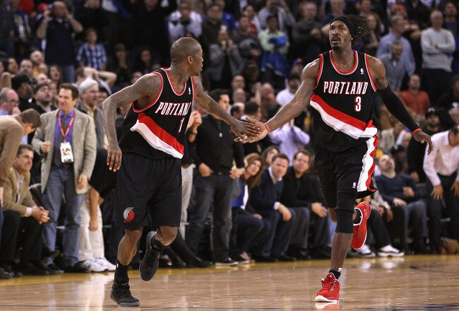 OAKLAND, CA - FEBRUARY 15:  Jamal Crawford #11 is congratulated by Gerald Wallace #3 of the Portland Trail Blazers after making a basket during their game against the Golden State Warriors at Oracle Arena on February 15, 2012 in Oakland, California. NOTE TO USER: User expressly acknowledges and agrees that, by downloading and or using this photograph, User is consenting to the terms and conditions of the Getty Images License Agreement.  (Photo by Ezra Shaw/Getty Images)