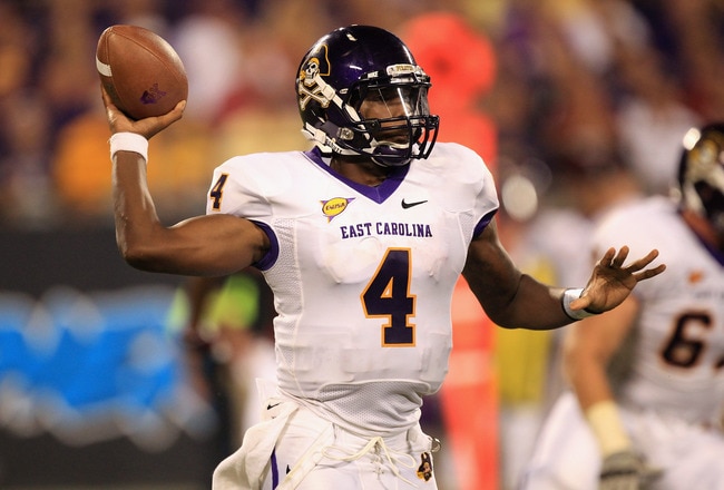 CHARLOTTE, NC - SEPTEMBER 03:  Dominique Davis #4 of the East Carolina Pirates drops back to pass against the South Carolina Gamecocks during their game at Bank of America Stadium on September 3, 2011 in Charlotte, North Carolina.  (Photo by Streeter Lecka/Getty Images)