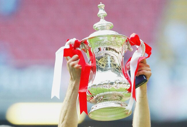 CARDIFF, WALES - MAY 22:  Ryan Giggs of Manchester United holds aloft thr trophy after victory over Millwall in the 123rd FA Cup Final between Manchester United and Millwall held at The Millennium Stadium on May 22, 2004 in Cardiff, Wales.  (Photo by Mike Hewitt/Getty Images)