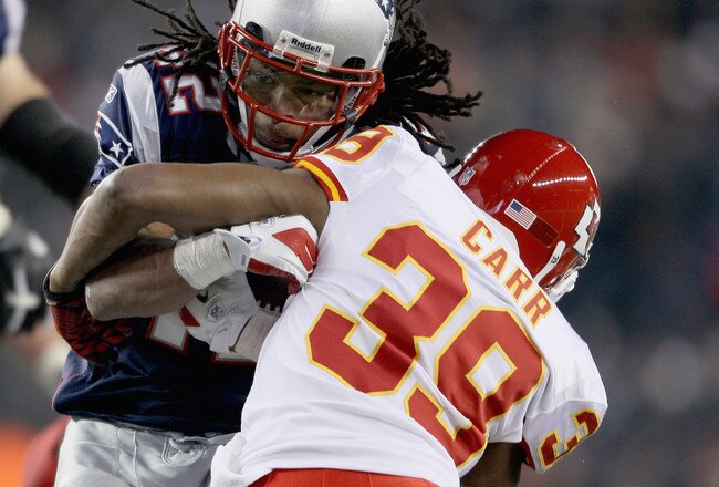 FOXBORO, MA - NOVEMBER 21:   BenJarvus Green-Ellis #42 of the New England Patriots is tackled by  Brandon Carr #39 of the Kansas City Chiefs on November 21, 2011 at Gillette Stadium in Foxboro, Massachusetts.  (Photo by Elsa/Getty Images)