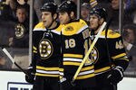 BOSTON, MA - JANUARY 05:  David Krejci #46 of the Boston Bruins is congratulated by teammates Milan Lucic #117 and Nathan Horton #18 after Krejci scored in the second period against the Calgary Flames on January 5, 2012 at TD Garden in Boston, Massachusetts.  (Photo by Elsa/Getty Images)