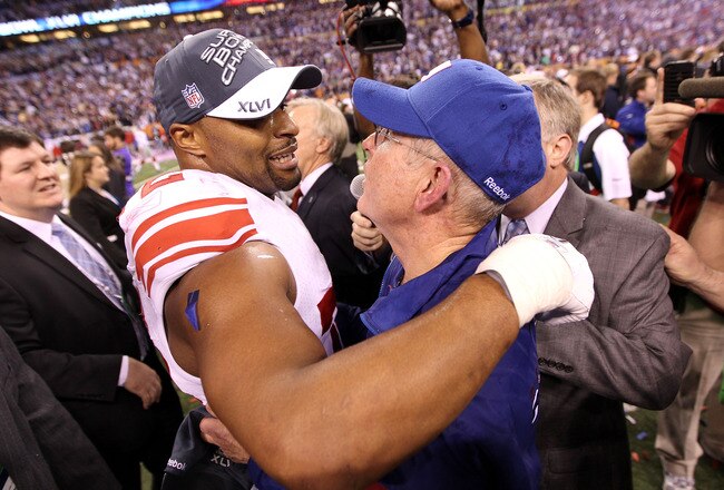 INDIANAPOLIS, IN - FEBRUARY 05:  Head coach Tom Coughlin of the New York Giants hugs Osi Umenyiora #72 on the field after defeating the New England Patriots in Super Bowl XLVI at Lucas Oil Stadium on February 5, 2012 in Indianapolis, Indiana. The New York Giants defeated the New England Patriots 21-17.  (Photo by Jamie Squire/Getty Images)