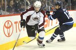 WINNIPEG, CANADA - FEBRUARY 19: Matt Duchene #9 of the Colorado Avalanche controls the puck behind the net during their NHL game as Randy Jones #12 of the Winnipeg Jets tries to defend at MTS Centre on February 19, 2012 in Winnipeg, Manitoba, Canada. (Photo by Tom Szczerbowski/Getty Images)
