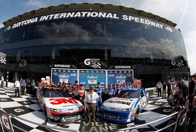 DAYTONA BEACH, FL - FEBRUARY 19:  Team owner Jack Roush poses in with pole position winner Carl Edwards, driver of the #99 Fastenal Ford, and 2nd position starter Greg Biffle, driver of the #16 3M Ford, in Victory Lane after qualifying for the NASCAR Sprint Cup Series Daytona 500 at Daytona International Speedway on February 19, 2012 in Daytona Beach, Florida.  (Photo by Todd Warshaw/Getty Images for NASCAR)