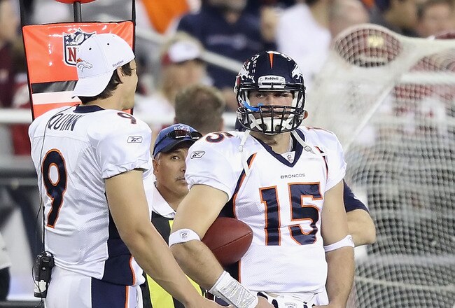 GLENDALE, AZ - DECEMBER 12:  Quarterbacks Brady Quinn #9 and Tim Tebow #15 of the Denver Broncos stand on the sideline during the NFL game against the Arizona Cardinals at the University of Phoenix Stadium on December 12, 2010 in Glendale, Arizona.   The Cardinals defeated the Broncos 43-13.  (Photo by Christian Petersen/Getty Images)