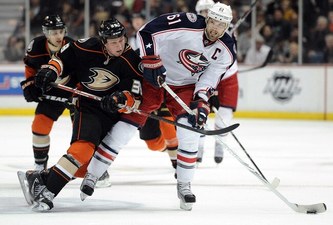 ANAHEIM, CA - FEBRUARY 03:  Rick Nash #61 of the Columbus Blue Jackets fends off Matt Beleskey #39 of the Anaheim Ducks as he carries the puck during the second period at Honda Center on February 3, 2012 in Anaheim, California.  (Photo by Harry How/Getty Images)