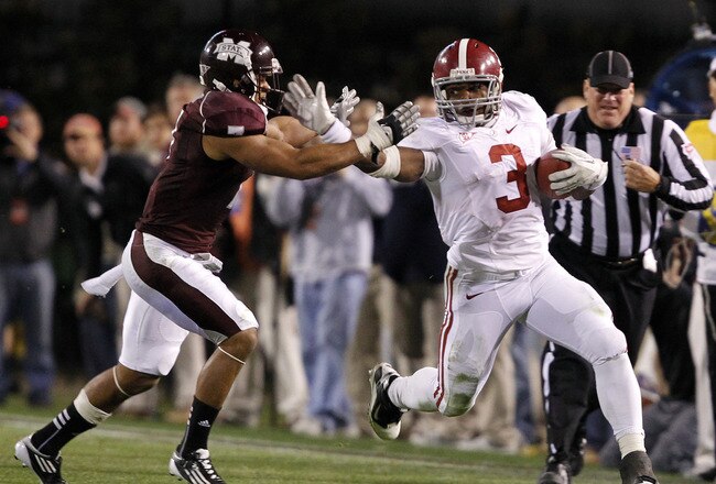 STARKVILLE, MS - NOVEMBER 12:  Running back Trent Richardson #3 of the Alabama Crimson Tide stiff arms defensive back Wade Bonner #7 of the Mississippi State Bulldogs during a big first down run in the fourth quarter on November 12, 2011 at Davis Wade Stadium in Starkville, Mississippi. (Photo by Butch Dill/Getty Images)