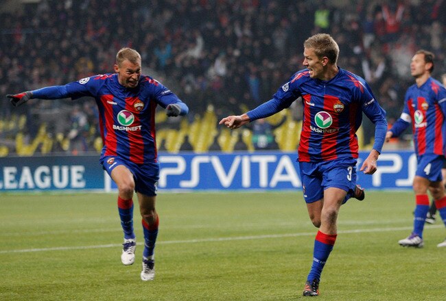 MOSCOW, RUSSIA - FEBRUARY 21: Pontus Wernbloom (R) of CSKA Moscow celebrates with team-mate Vasili Berezutsky after scoring an equaliser in stoppage time during the UEFA Champions League round of 16, first leg match between CSKA Moscow and Real Madrid at the Luzhniki Stadium on February 21, 2012 in Moscow, Russia.  (Photo by Harry Engels/Getty Images)