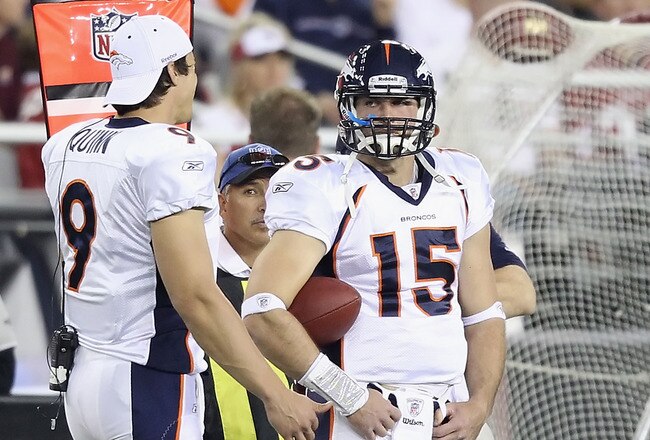 GLENDALE, AZ - DECEMBER 12:  Quarterbacks Brady Quinn #9 and Tim Tebow #15 of the Denver Broncos stand on the sideline during the NFL game against the Arizona Cardinals at the University of Phoenix Stadium on December 12, 2010 in Glendale, Arizona.   The Cardinals defeated the Broncos 43-13.  (Photo by Christian Petersen/Getty Images)