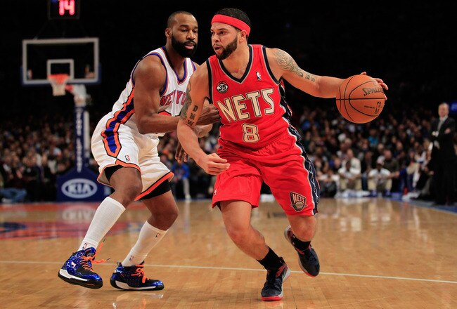 NEW YORK, NY - FEBRUARY 20: Deron Williams #8 of the New Jersey Nets dribbles past Baron Davis #85 of the New York Knicks at Madison Square Garden on February 20, 2012 in New York City. NOTE TO USER: User expressly acknowledges and agrees that, by downloading and/or using this Photograph, user is consenting to the terms and conditions of the Getty Images License Agreement.  (Photo by Chris Trotman/Getty Images)