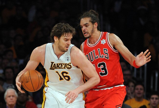 LOS ANGELES, CA - DECEMBER 25:  Pao Gasol #16 of the Los Angeles Lakers drives against Joakim Noah #13 of the Chicago Bulls at Staples Center on December 25, 2011 in Los Angeles, California.  NOTE TO USER: User expressly acknowledges and agrees that, by downloading and or using this photograph, User is consenting to the terms and conditions of the Getty Images License Agreement.  (Photo by Lisa Blumenfeld/Getty Images)