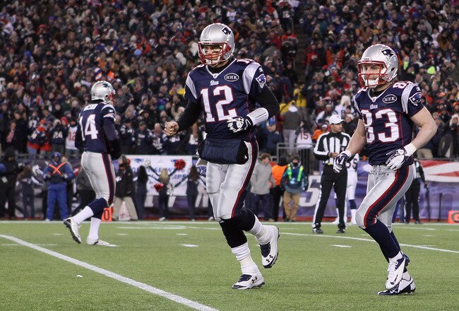 FOXBORO, MA - JANUARY 14:  (L-R) Tom Brady #12 and Wes Welker #83 of the New England Patriots run to the sideline after Welker caught a 7-yard touchdown reception from Brady in the first quarter against the Denver Broncos during their AFC Divisional Playoff Game at Gillette Stadium on January 14, 2012 in Foxboro, Massachusetts.  (Photo by Elsa/Getty Images)