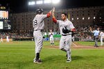 BALTIMORE, MD - SEPTEMBER 28:  Mike Aviles #3 of the Boston Red Sox celebrates with Adrian Gonzalez #28 after scoring in the third inning against the Baltimore Orioles at Oriole Park at Camden Yards on September 28, 2011 in Baltimore, Maryland.  (Photo by Greg Fiume/Getty Images)