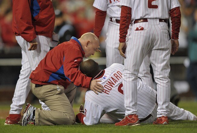 PHILADELPHIA, PA - OCTOBER 07:  Ryan Howard #6 of the Philadelphia Phillies is tended to after he was hurt on the last play of the game as the Phillies lost 1-0 against the St. Louis Cardinals during Game Five of the National League Divisional Series at Citizens Bank Park on October 7, 2011 in Philadelphia, Pennsylvania.  (Photo by Drew Hallowell/Getty Images)