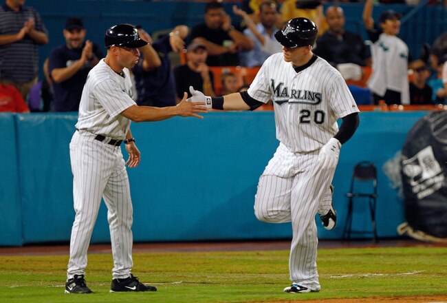 MIAMI GARDENS, FL - SEPTEMBER 26:  Logan Morrison #20 of the Florida Marlins is congratulated by third base coach Joey Espada #4 after hitting a solo homerun during a game  at Sun Life Stadium on September 26, 2011 in Miami Gardens, Florida.  (Photo by Mike Ehrmann/Getty Images)