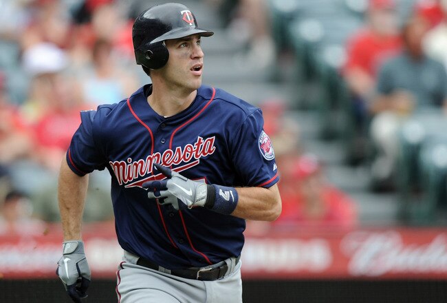 ANAHEIM, CA - SEPTEMBER 04:  Joe Mauer #7 of the Minnesota Twins watches his solo homerun for a 1-1 tie against the Los Angeles Angels of Anaheim during the fourth inning at Angel Stadium of Anaheim on September 4, 2011 in Anaheim, California.  (Photo by Harry How/Getty Images)