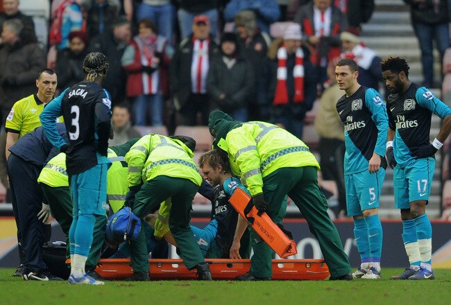 SUNDERLAND, ENGLAND - FEBRUARY 11: Per Mertesacker of Arsenal is put on a stretcher as he is substituted after suffering an injury during the Barclays Premier League match between Sunderland and Arsenal at the Stadium of Light on February 11, 2012 in Sunderland, England.  (Photo by Michael Regan/Getty Images)