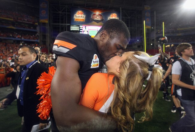 GLENDALE, AZ - JANUARY 02:  Justin Blackmon #81 of the Oklahoma State Cowboys celebrates by kissing his girlfriend and cheerleader Mariel Dunlap after Oklahoma State Cowboys won 41-38 in overtime against the Stanford Cardinal during the Tostitos Fiesta Bowl on January 2, 2012 at University of Phoenix Stadium in Glendale, Arizona.  (Photo by Donald Miralle/Getty Images)