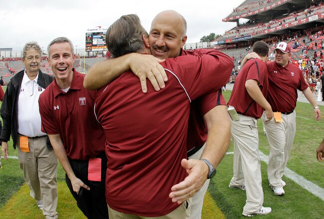 COLLEGE PARK, MD - SEPTEMBER 24: Head coach Steve Addazio (3R) of the Temple Owls hugs athletic director Bill Bradshaw after the Owls defeated the Maryland Terrapins 38-7 at Byrd Stadium on September 24, 2011 in College Park, Maryland.  (Photo by Rob Carr/Getty Images)