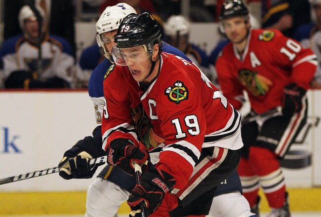 CHICAGO, IL - FEBRUARY 19:  Jonathan Toews #19 of the Chicago Blackhawks controls the puck under pressure from Jamie Langenbrunner #15 of the St. Louis Blues at the United Center on February 19, 2012 in Chicago, Illinois. The Blackhawks defeated the Blues 3-1.  (Photo by Jonathan Daniel/Getty Images)