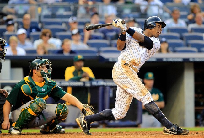 NEW YORK, NY - AUGUST 25: Curtis Granderson #14 of the New York Yankees hits a grand slam home run in the 8th inning in front of catcher Anthony Recker of the Oakland Athletics at Yankee Stadium on August 25, 2011 at Yankee Stadium in the Bronx borough of New York City. The Yankees are the first team in MLB history to hit three grand slams in a single game.  (Photo by Chris Trotman/Getty Images)
