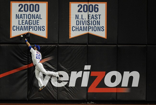 NEW YORK, NY - SEPTEMBER 27:  Jason Pridie #20 leaps to catch a ball hit by Drew Stubbs of the Cincinnati Reds in the eleventh inning during a game at Citi Field on September 27, 2011 in the Flushing neighborhood of the Queens borough of New York City. Stubbs tripled on the play. (Photo by Patrick McDermott/Getty Images)
