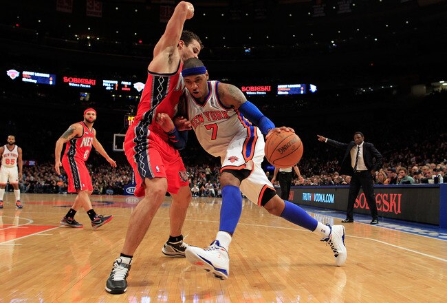 NEW YORK, NY - FEBRUARY 20: Carmelo Anthony #7 of the New York Knicks drives against Kris Humphries #43 of the New Jersey Nets at Madison Square Garden on February 20, 2012 in New York City. NOTE TO USER: User expressly acknowledges and agrees that, by downloading and/or using this Photograph, user is consenting to the terms and conditions of the Getty Images License Agreement.  (Photo by Chris Trotman/Getty Images)