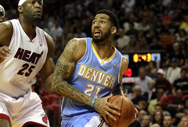 MIAMI, FL - MARCH 19:  Forward Wilson Chandler #21 of the Denver Nuggets drives against Center Erick Dampier #25 of the Miami Heat at American Airlines Arena on March 19, 2011 in Miami, Florida.  The Heat defeated the Nuggets 103-98. NOTE TO USER: User expressly acknowledges and agrees that, by downloading and/or using this Photograph, User is consenting to the terms and conditions of the Getty Images License Agreement.  (Photo by Marc Serota/Getty Images)