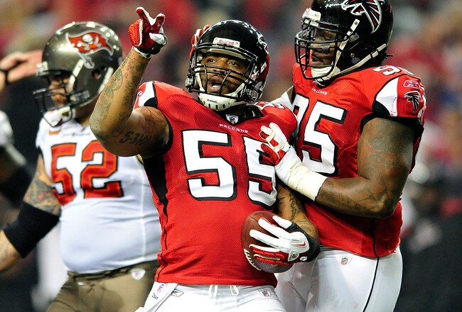 ATLANTA, GA - JANUARY 01:  John Abraham #55 and Jonathan Babineaux #95 of the Atlanta Falcons celebrate after Abraham's sack and fumble recovery against the Tampa Bay Buccaneers during play at the Georgia Dome on January 1, 2012 in Atlanta, Georgia.  (Photo by Grant Halverson/Getty Images)