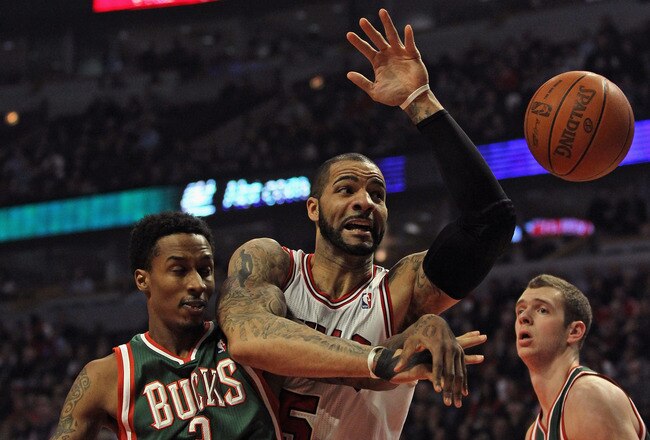 CHICAGO, IL - FEBRUARY 22: Carlos Boozer #5 of the Chicago Bulls and Brandon Jennings #3 of the Milwaukee Bucks battle for a loose ball at the United Center on February 22, 2012 in Chicago, Illinois. NOTE TO USER: User expressly acknowledges and agrees that, by downloading and or using this photograph, User is consenting to the terms and conditions of the Getty Images License Agreement. (Photo by Jonathan Daniel/Getty Images)