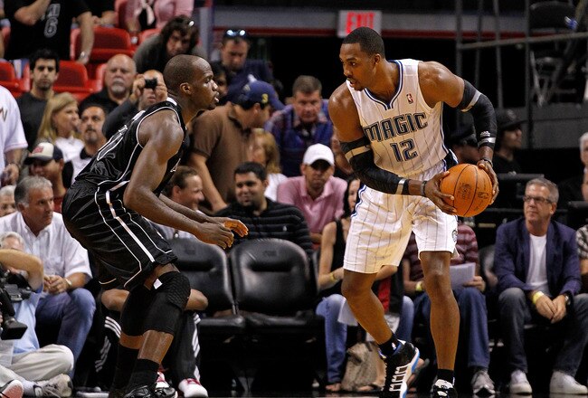 MIAMI, FL - FEBRUARY 19:  Dwight Howard #12 of the Orlando Magic posts up Joel Anthony #50 of the Miami Heat during a game  at American Airlines Arena on February 19, 2012 in Miami, Florida. NOTE TO USER: User expressly acknowledges and agrees that, by downloading and/or using this Photograph, User is consenting to the terms and conditions of the Getty Images License Agreement.  (Photo by Mike Ehrmann/Getty Images)