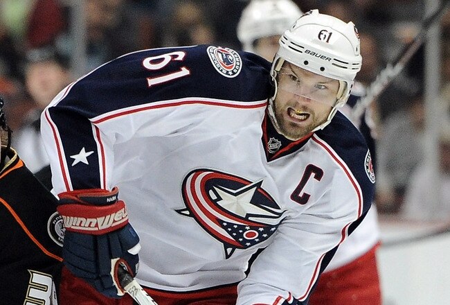 ANAHEIM, CA - FEBRUARY 03:  Rick Nash #61 of the Columbus Blue Jackets fends off Matt Beleskey #39 of the Anaheim Ducks as he carries the puck during the second period at Honda Center on February 3, 2012 in Anaheim, California.  (Photo by Harry How/Getty Images)