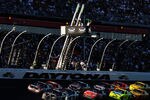 DAYTONA BEACH, FL - FEBRUARY 20:  Ryan Newman, driver of the #39 U.S. Army Chevrolet, and Denny Hamlin, driver of the #11 FedEx Toyota, lead a pack of cars past the green flag for a restart during the NASCAR Sprint Cup Series Daytona 500 at Daytona International Speedway on February 20, 2011 in Daytona Beach, Florida.  (Photo by Jason Smith/Getty Images for NASCAR)