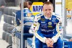DAYTONA BEACH, FL - FEBRUARY 22:  Mark Martin, driver of the #55 Aaron's Toyota, sits behind the team hauler in the garage area during practice for the NASCAR Sprint Cup Series Daytona 500 at Daytona International Speedway on February 22, 2012 in Daytona Beach, Florida.  (Photo by Todd Warshaw/Getty Images for NASCAR)