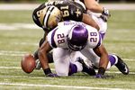 NEW ORLEANS - JANUARY 24:  Adrian Peterson #28 of the Minnesota Vikings fumbles the ball as he was hit by Jonathan Vilma #51 of the New Orleans Saints during the NFC Championship Game at the Louisiana Superdome on January 24, 2010 in New Orleans, Louisiana.  (Photo by Chris Graythen/Getty Images)