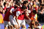 LONDON, ENGLAND - FEBRUARY 26:  Theo Walcott of Arsenal is mobbed by team mates after scoring his second goal during the Barclays Premier League match between Arsenal and Tottenham Hotspur at Emirates Stadium on February 26, 2012 in London, England.  (Photo by Clive Mason/Getty Images)