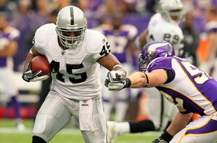 MINNEAPOLIS, MN - NOVEMBER 20:   Marcel Reece #45 of the Oakland Raiders carries the ball for a gain against  Chad Greenway #52 of the Minnesota Vikings on November 20, 2011 at Mall of America Field at Hubert H. Humphrey Metrodome in Minneapolis, Minnesota.  (Photo by Adam Bettcher /Getty Images)