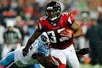 ATLANTA, GA - NOVEMBER 20:  Michael Turner #33 of the Atlanta Falcons breaks away from Malcolm Sheppard #96 of the Tennessee Titans during play at the Georgia Dome on November 20, 2011 in Atlanta, Georgia.  (Photo by Grant Halverson/Getty Images)