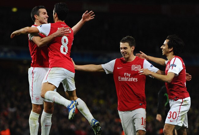 LONDON, ENGLAND - NOVEMBER 23:  Mikel Arteta of Arsenal congratulates goal scorer Robin van Persie of Arsenal on scoring his second goal during the UEFA Champions League Group F match between Arsenal FC and Borussia Dortmund  at Emirates Stadium on November 23, 2011 in London, England.  (Photo by Mike Hewitt/Getty Images)